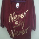 Maroon with gold writing "never say never" loose fitting top is being swapped online for free