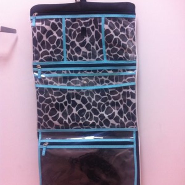 black and teal hanging organizer with teal pouch is being swapped online for free