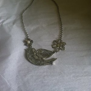 Silver flower and bird necklace  is being swapped online for free