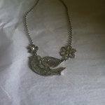 Silver flower and bird necklace  is being swapped online for free