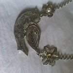 Silver flower and bird necklace  is being swapped online for free