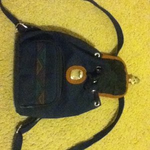 dark blue/ tan backpack purse is being swapped online for free
