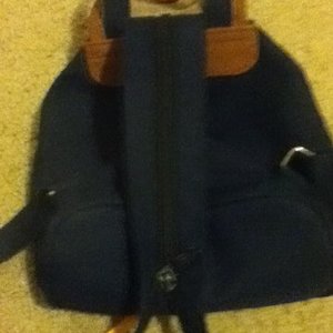 dark blue/ tan backpack purse is being swapped online for free