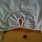 White spaghetti top with peep-hole and blue sequins is being swapped online for free