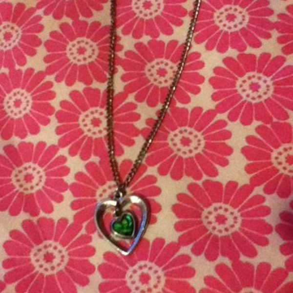 Silver heart with green heart necklace is being swapped online for free
