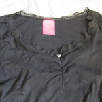 Black top with lace neck is being swapped online for free