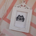 Cross stitch baby Pusheen necklace is being swapped online for free