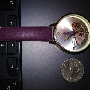New Peacock Dark Burgandy Accutime Womens Watch Silver Face New Battery is being swapped online for free