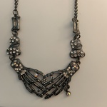 Silver Skeleton Hands Set with Gems Necklace is being swapped online for free