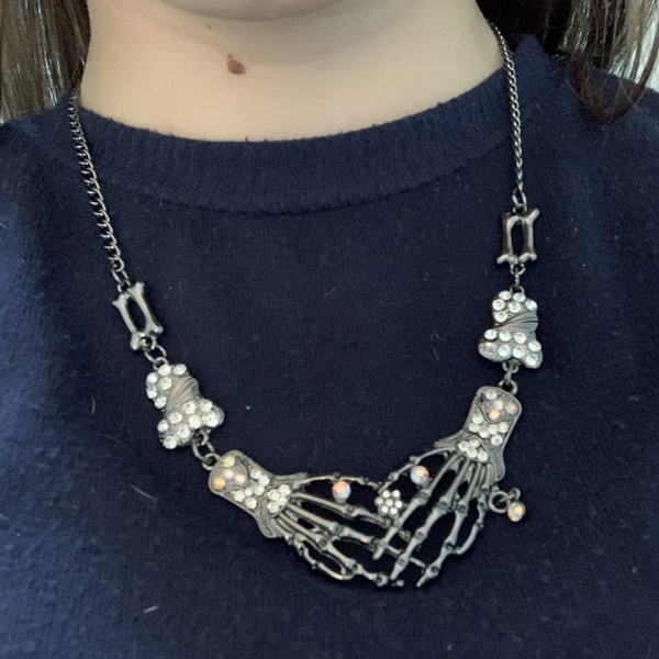 Silver Skeleton Hands Set with Gems Necklace is being swapped online for free