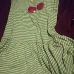 A green and white dress with a charry and a flower is being swapped online for free