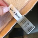 Pink Blush White Calvin Klein monogram scarf is being swapped online for free